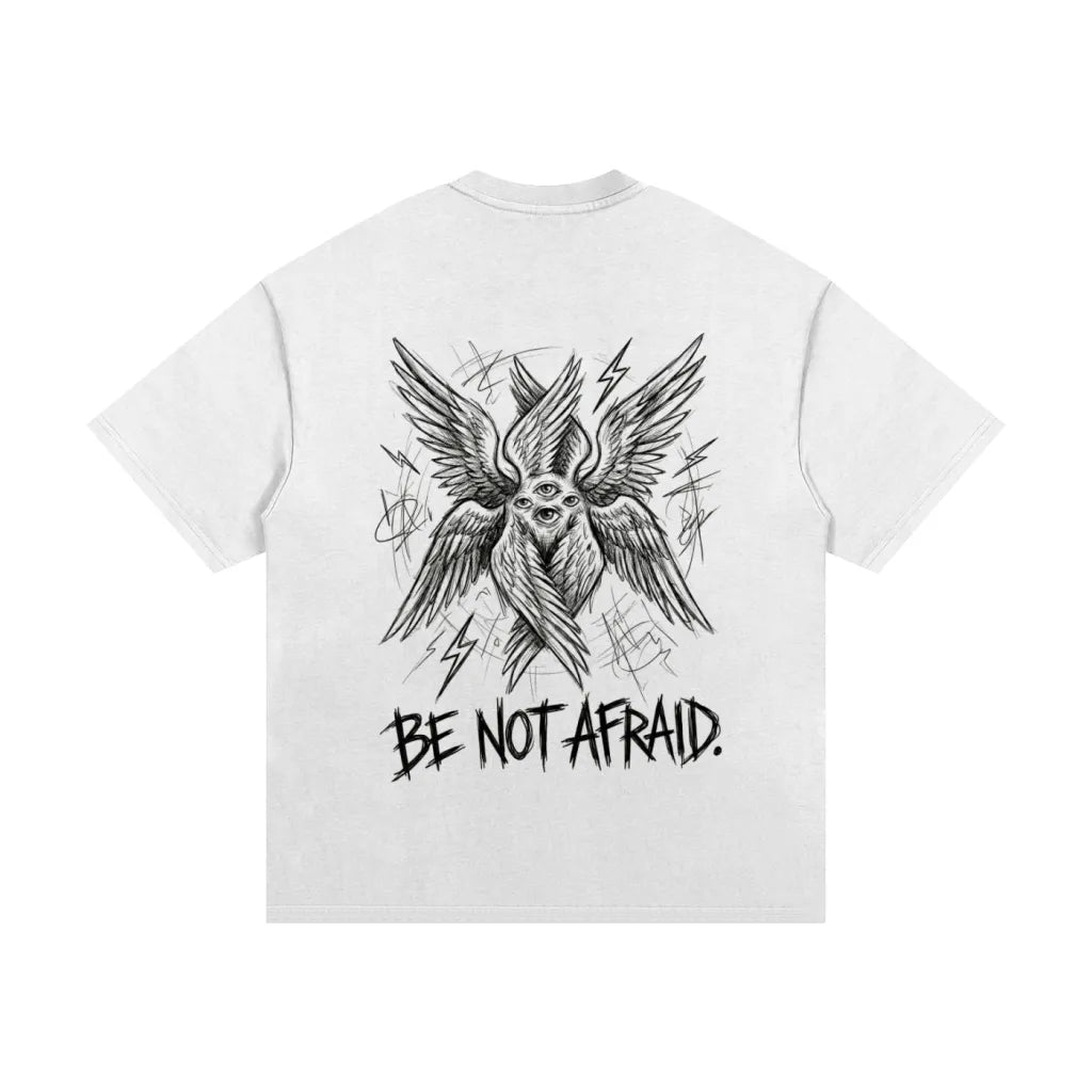 White t-shirt with black graphic design and 'Be Not Afraid' text on a white background